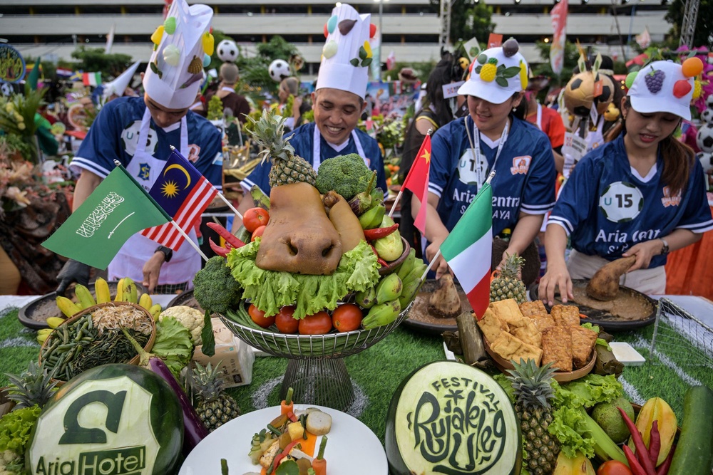 Food inspectors been dispatched to restaurants, food trucks and even temporary tents to ensure health standards are being followed. Pictured: Participants dressed in soccer uniforms take part in a festival in Indonesia to welcome the upcoming FIFA World Cup (AFP via Getty Images)