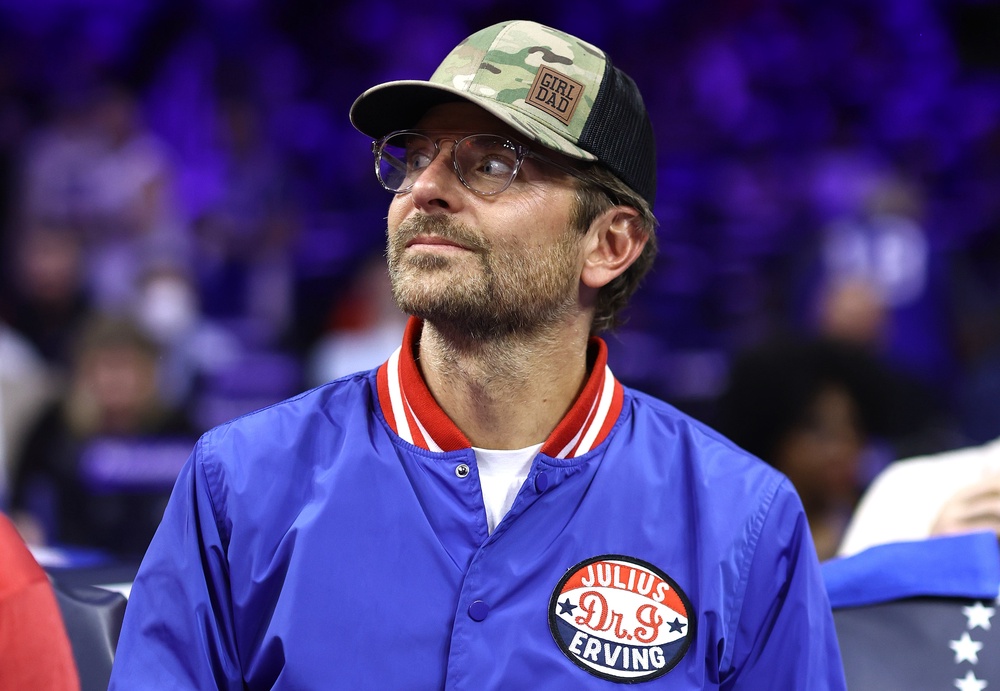 Bradley Cooper wore a camo trucker hat printed with ‘Girl Dad’ to a New York Knicks game in 2024. He is father to nine-year-old Lea De Seine Shayk Cooper, whom he shares with his ex Irina Shayk (Getty Images)