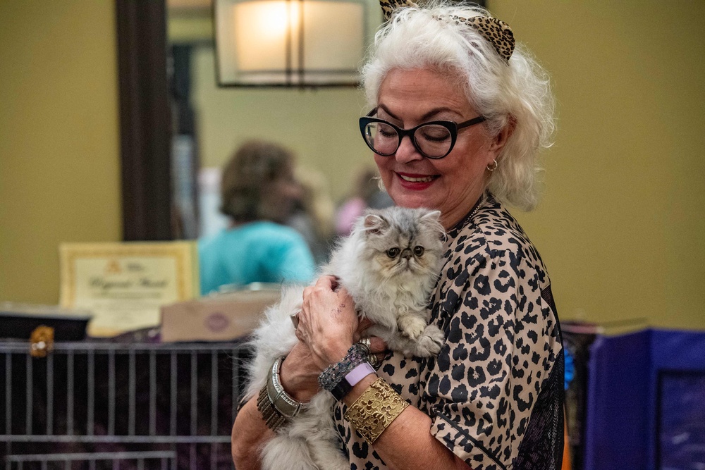 Sandra Marsinelli holds her cat Shiny Silver Nickel during the New England Meow Outfit's 10th Annual Allbreed and Household Pet Cat Show in Natick, Massachusetts, in August 2023. Pet owners should frequently check their cats for ticks and keep their cats inside in tick-laden areas. (AFP/Getty)