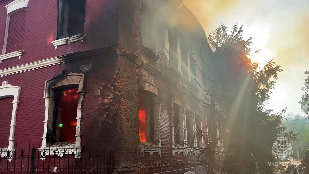Flames and smoke rise from the side of a college building damaged by Ukrainian drones in Starobilsk, Ukraine (Russian Emergency Ministry Press Service/AP)