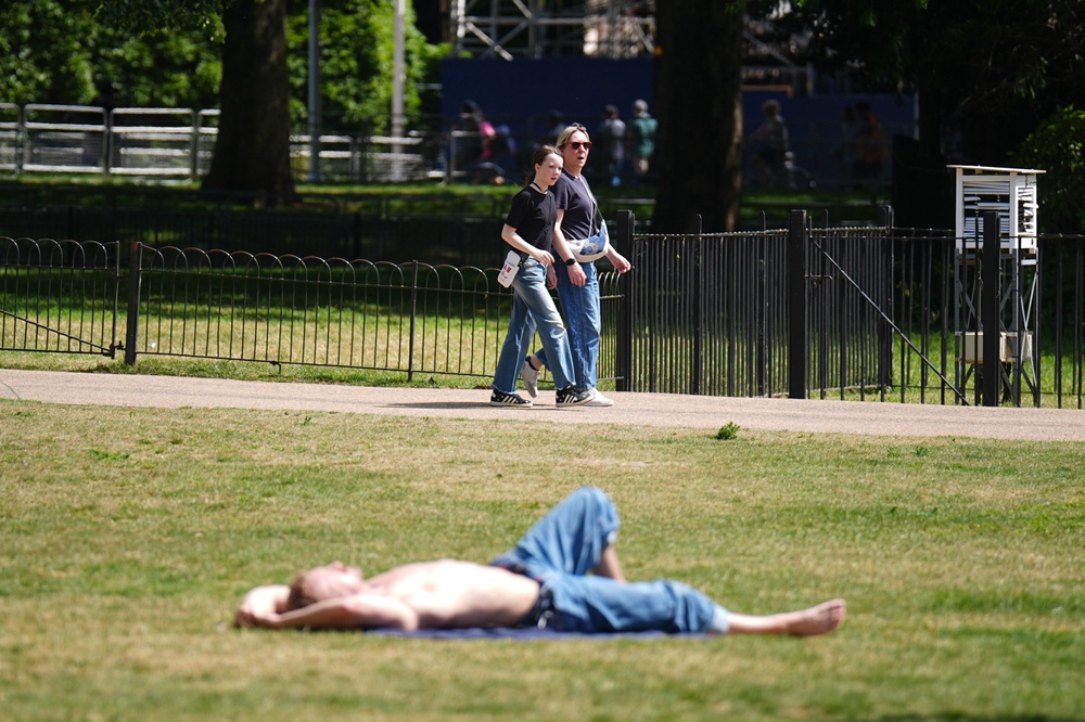 People enjoy the hot weather in St James’s Park in London (James Manning/PA) (PA Wire)