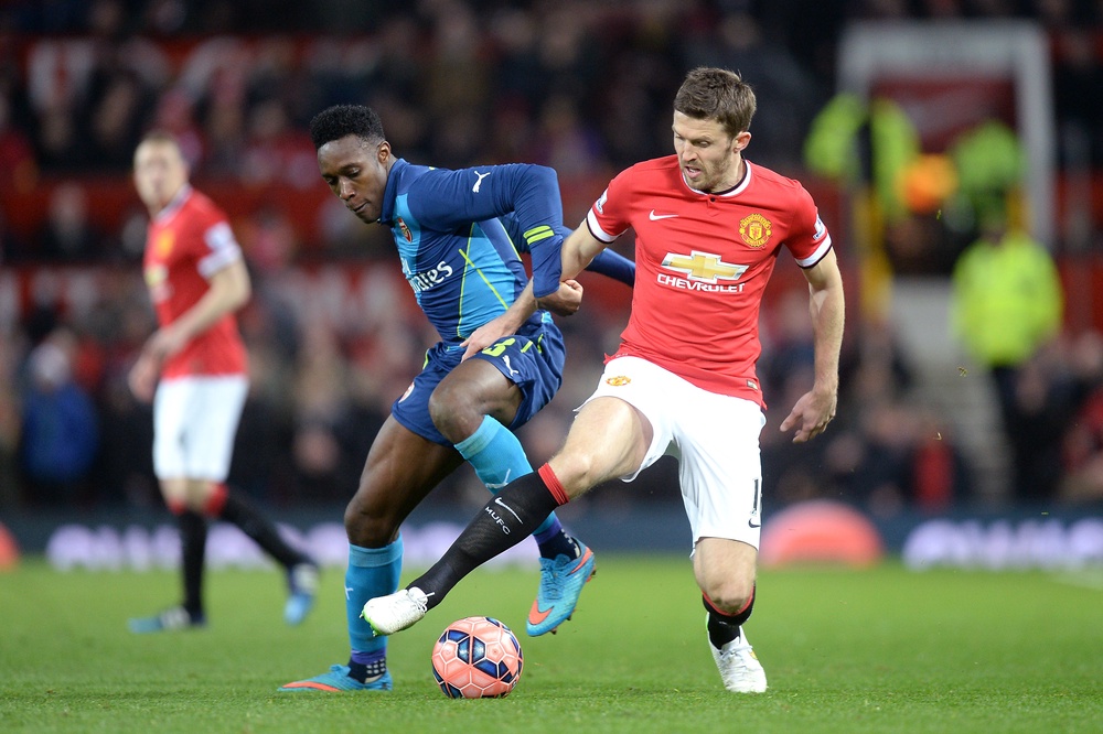 Carrick (right) and Danny Welbeck (left) battle for the ball (Martin Rickett/PA) (PA Archive)