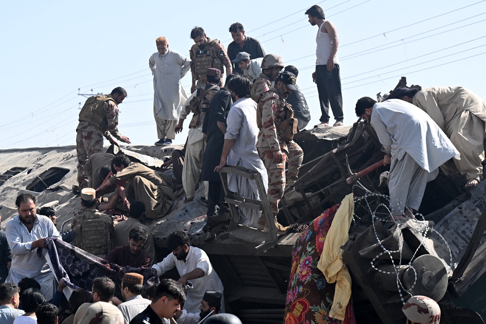 Security personnel and residents rescue injured blast victims from derailed carriages after an explosion targeted a train in Quetta (AFP/Getty)