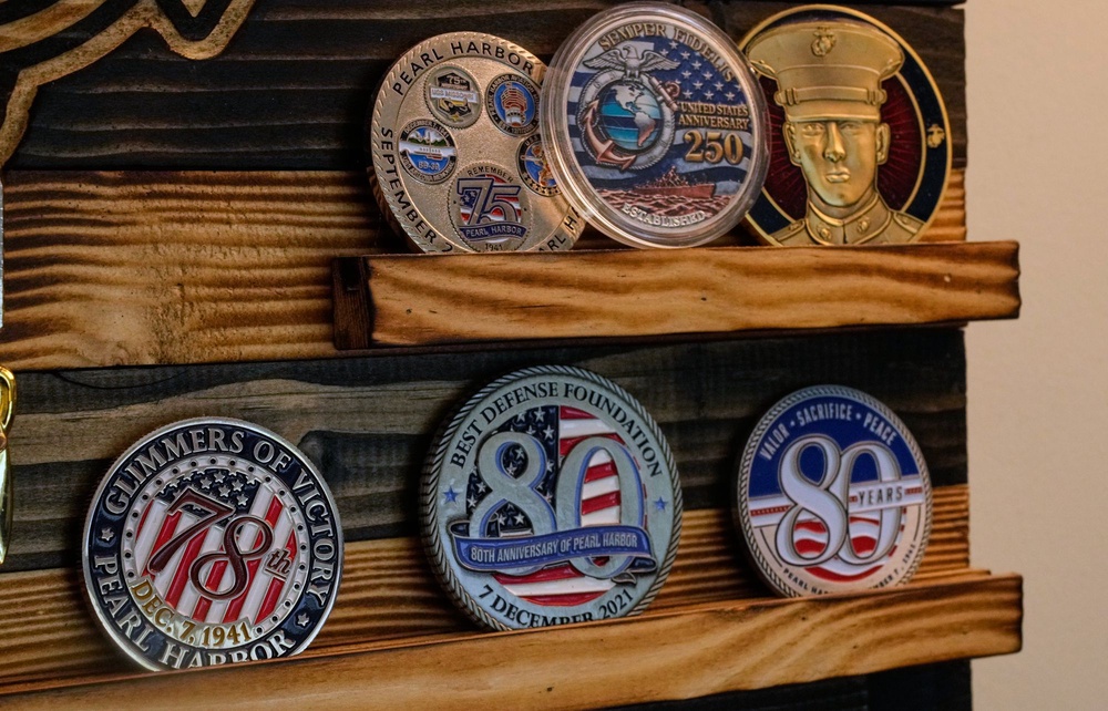 His living room is a testament to his Navy service, adorned with mementos, photographs of the St. Louis, and himself as a young sailor, alongside a collection of Navy challenge coins and ribbons (AP Photo/Charles Krupa)