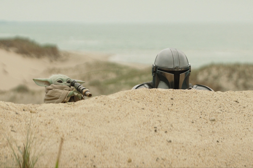 The Mandalorian, portrayed by Pedro Pascal, right, and Grogu in a scene from ‘Star Wars: The Mandalorian and Grogu’ (Lucasfilm)