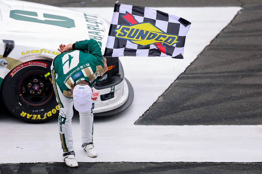 Layne Riggs, driver of the #34 University of North Carolina at Charlotte Ford, takes a bow in tribute to the late Kyle Busch after winning the NASCAR Craftsman Truck Series North Carolina Education Lottery 200 (Getty Images)