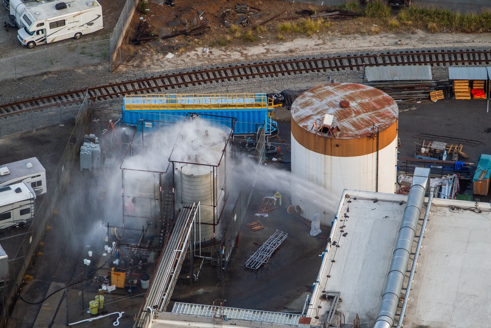 An aerial view of water being sprayed onto an overheated 34,000-gallon tank at GKN Aerospace. (Getty)