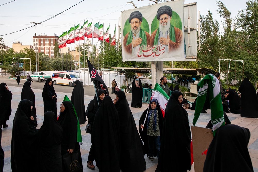 Iranians gather outside the Imam Khomeini Mosalla Mosque during an event to commemorate those killed in the current US-Israeli war (Getty)