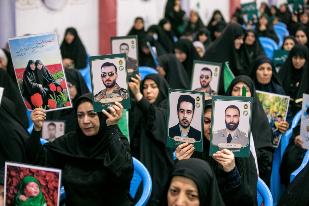 People hold portraits of the dead at the Imam Khomeini Mosalla Mosque to commemorate those killed in the current US-Israeli war as well as previous wars on May 24, 2026 in Tehran (Getty)