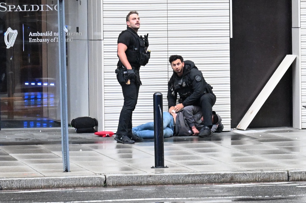 Secret Service agents, seen responding to an injured man, returned fire after a gunman shot toward a White House checkpoint on May 23. The suspect, identified as Nasine Best, was fatally shot (Getty)