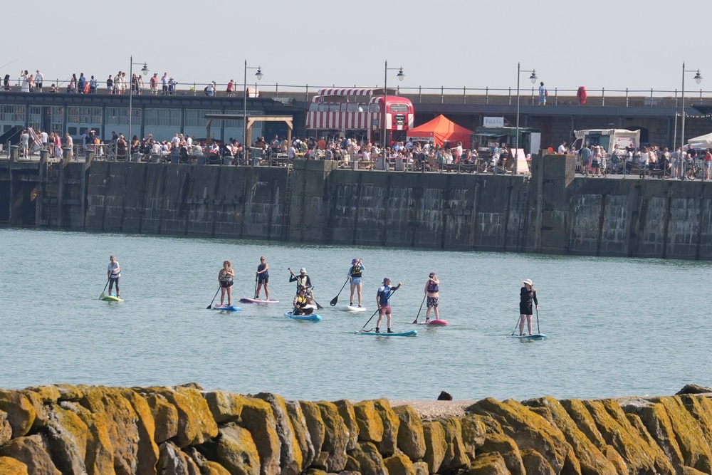 Paddleboarders at nearby Sunny Sands beach opted for a cooler form of transport (Gareth Fuller/PA) (PA Wire)