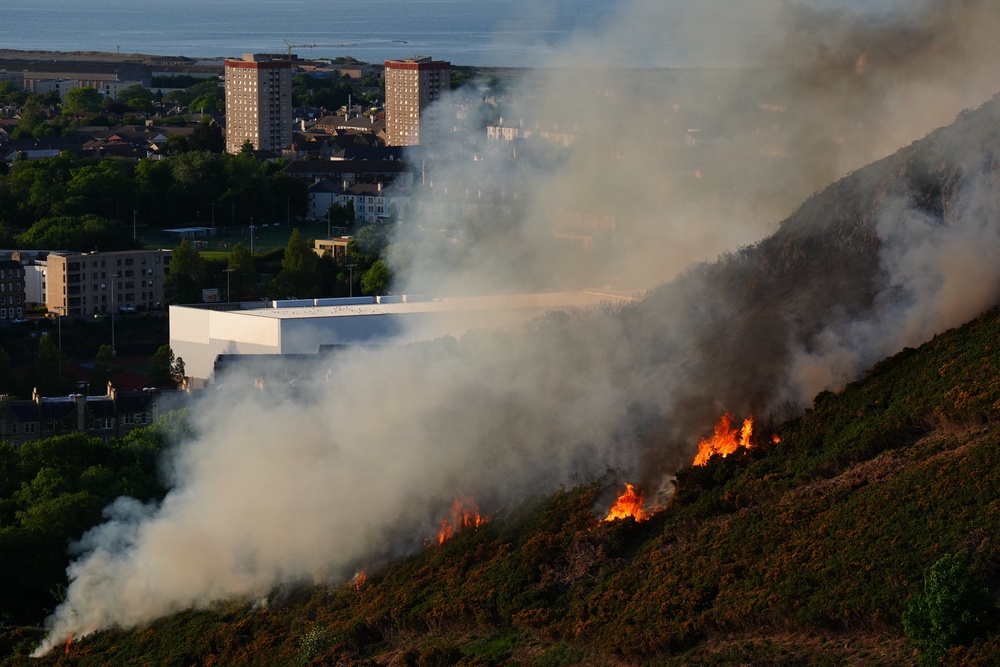 Flames and smoke rise from a fire close to the ruins of St Anthony’s Chapel in Holyrood Park, Edinburgh (Jane Barlow/PA) (PA Wire)