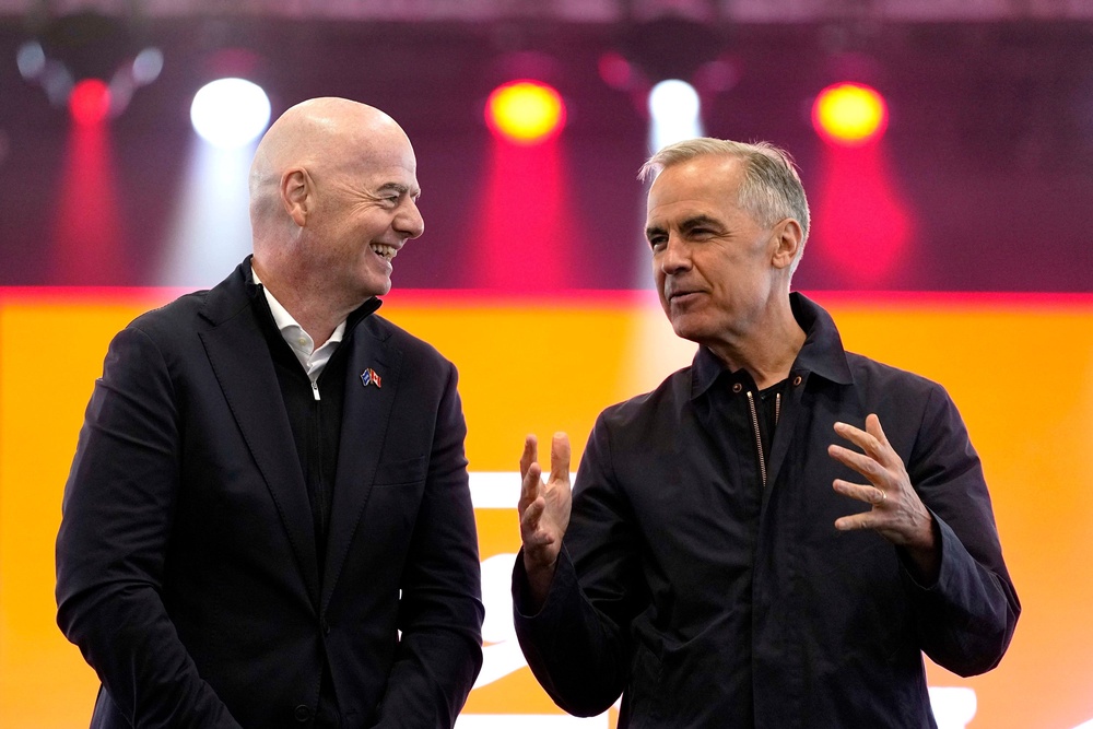 Prime Minister Mark Carney, right, and FIFA President Gianni Infantino speak during a World Cup trophy tour event in Ottawa, on Sunday (Justin Tang/The Canadian Press/AP) (AP)