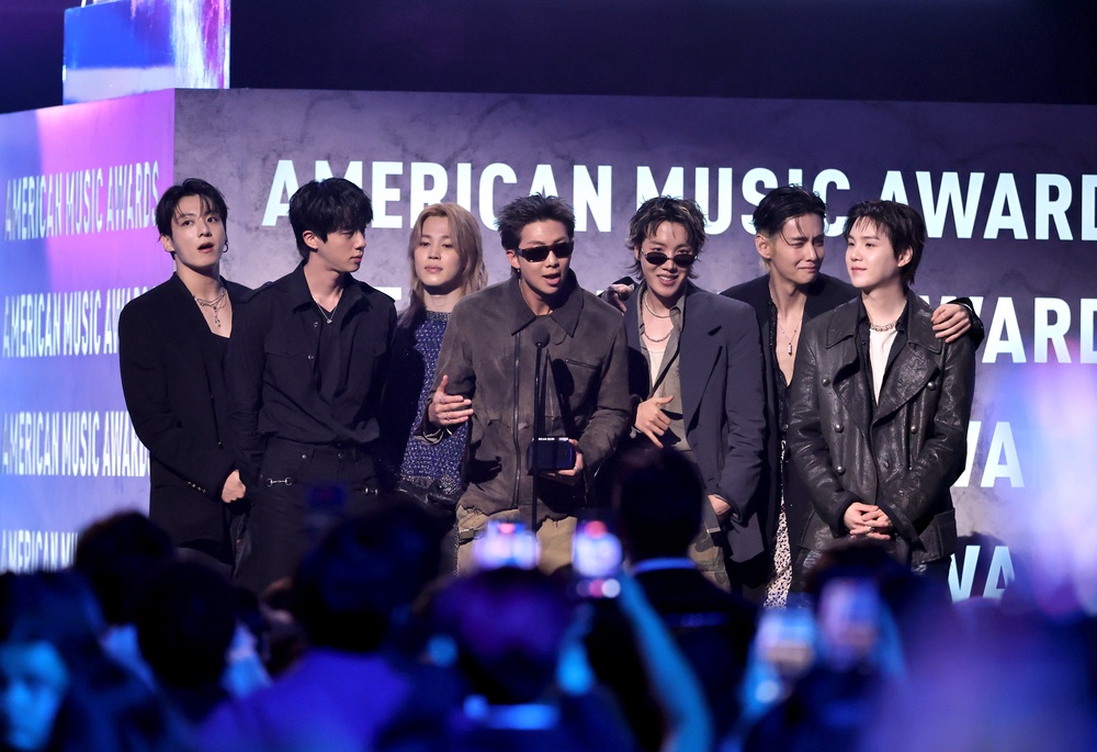 Jungkook, Jin, Jimin, RM, J-Hope, V and Suga of BTS accept the Artist of the Year award onstage during the 52nd American Music Awards (Getty)