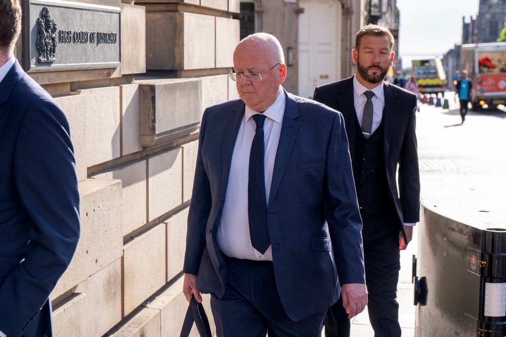 Former SNP chief executive Peter Murrell, centre, arrives at Edinburgh High Court where he pleaded guilty to embezzling funds (PA)