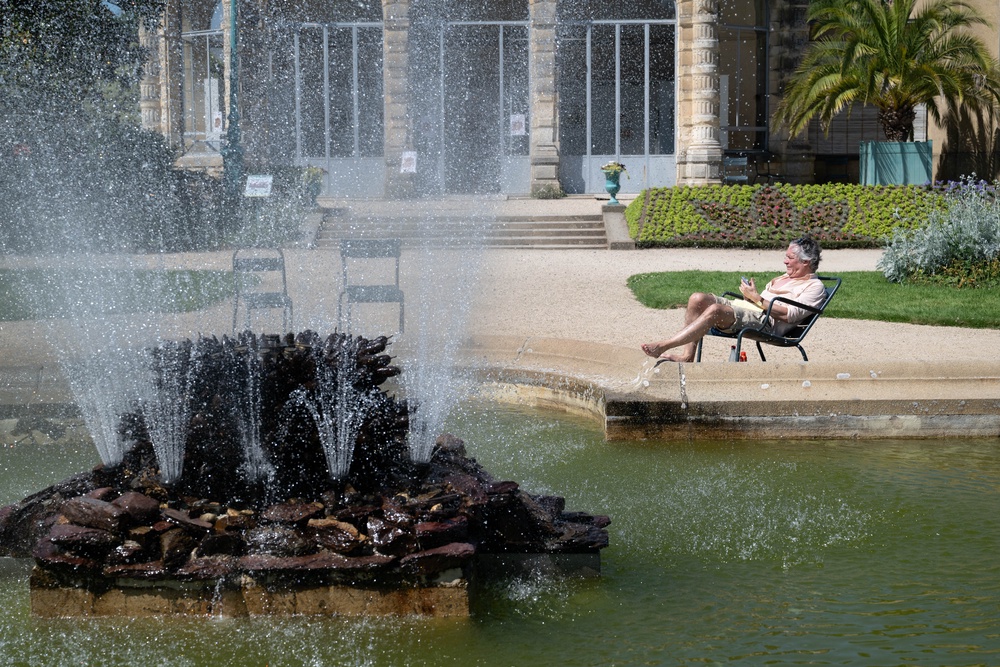 A man sits by a fountain at the Thabor park in Rennes, during a heatwave affecting western France on May 25 (AFP/Getty)