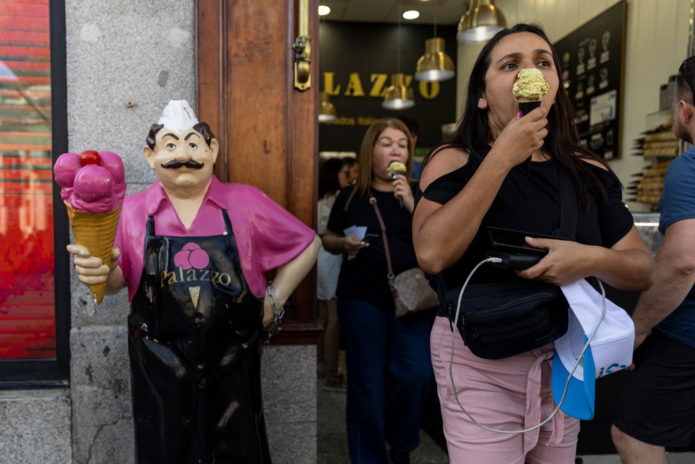 People buy ice-creams at Puerta del Sol square during an early heatwave in Madrid, on 23 May (Getty)