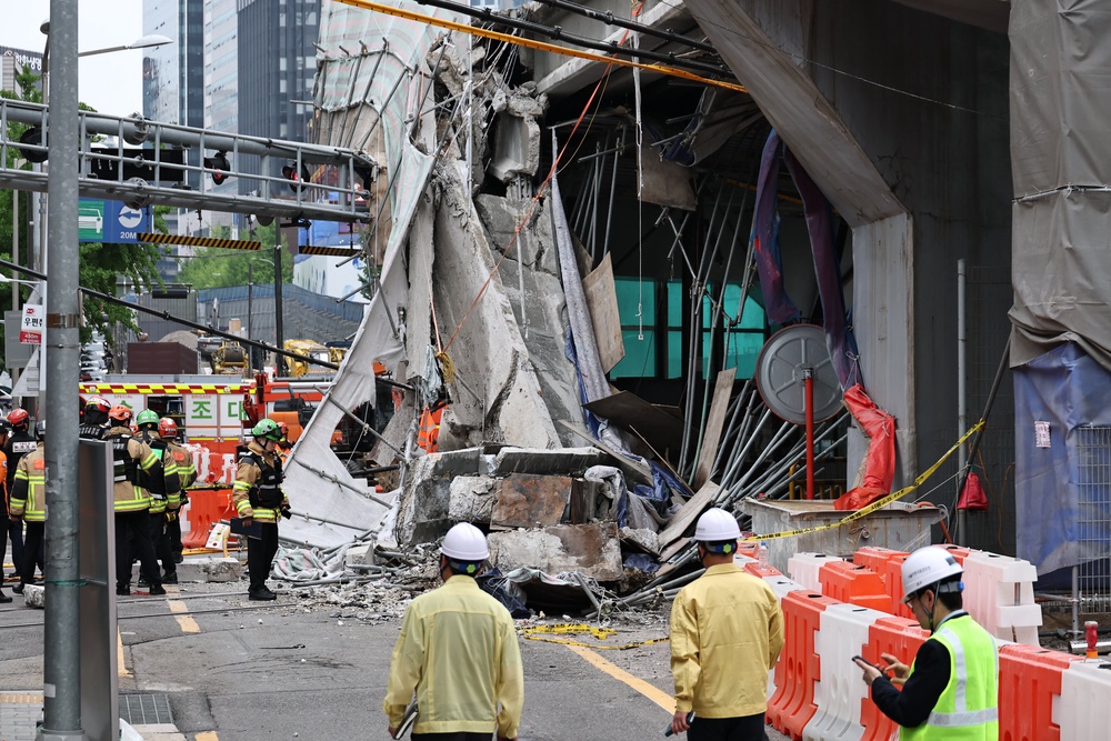 South Korean rescue team inspect the scene where an overpass collapsed while it was being dismantled in Seoul, South Korea, Tuesday (AP)