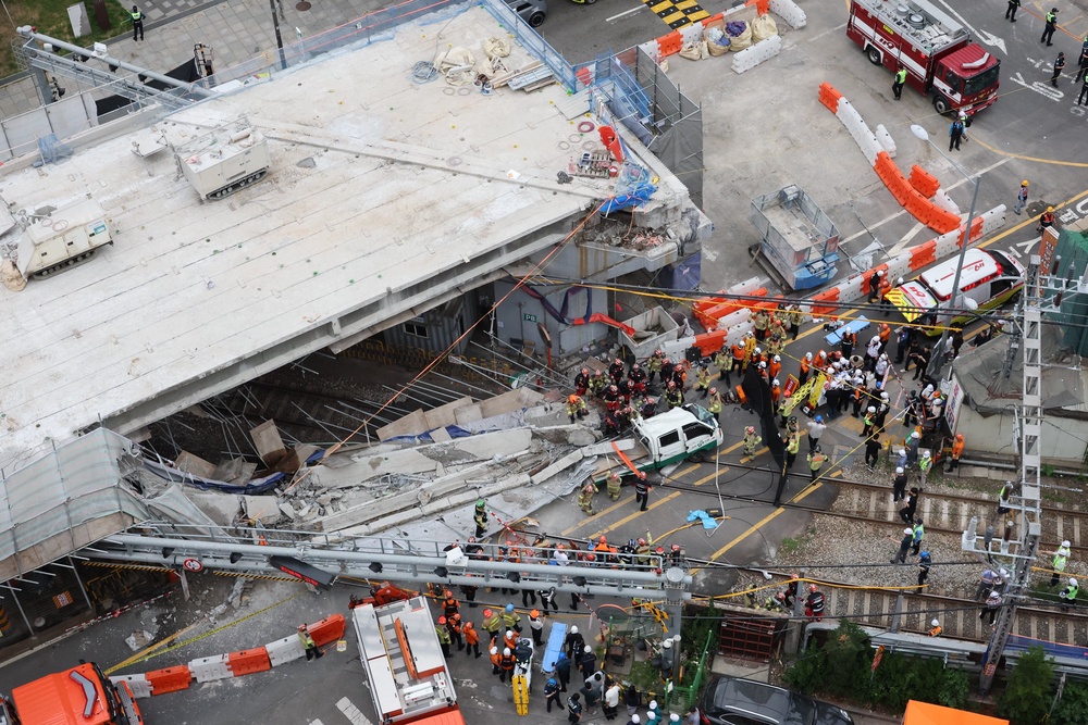 Rescue workers working on the site in Seoul (AP)