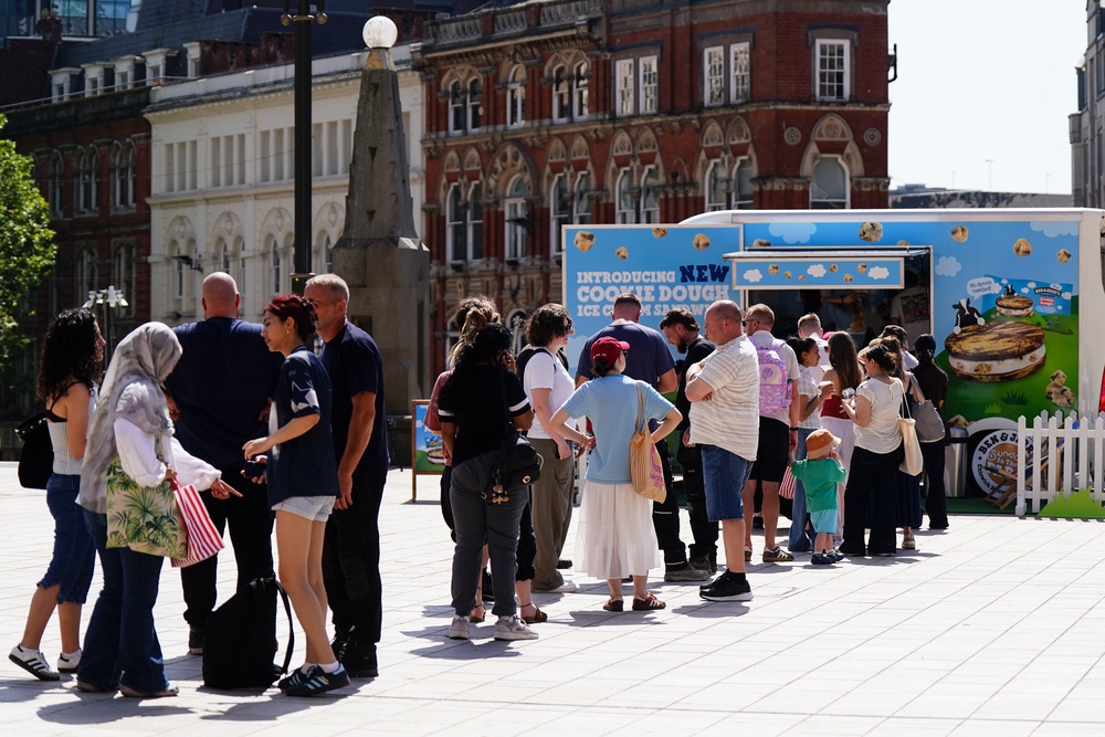 People queue for ice creams in Birmingham (PA)