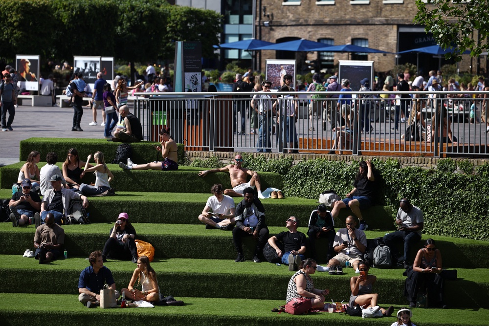 People relax in the sunshine beside the Regent's canal in London (AFP/Getty)