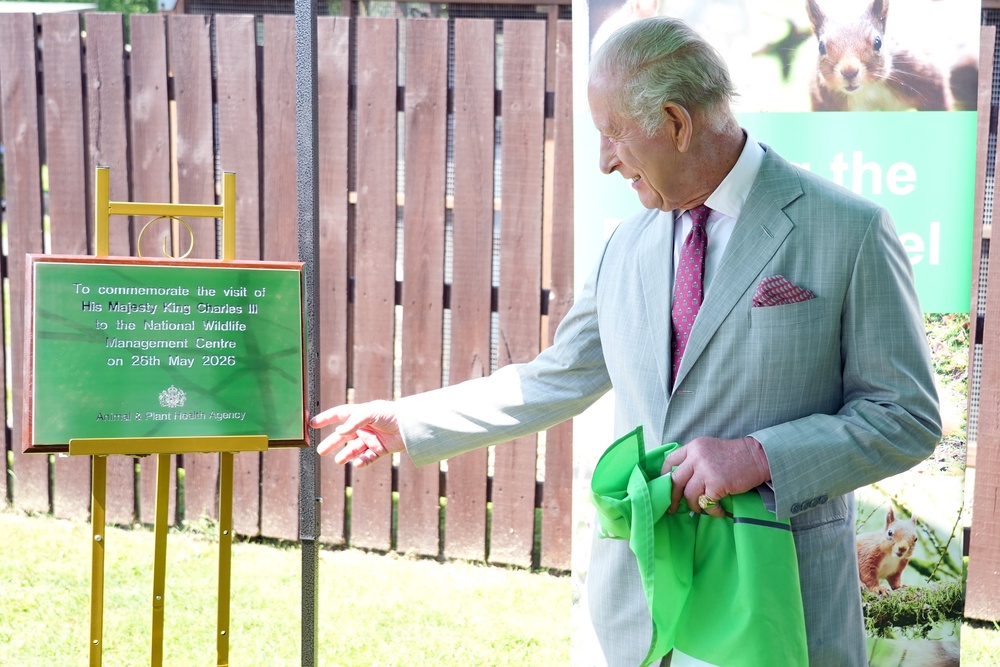 King Charles III unveils a plaque during a visit to a conservation initiative to humanely control grey squirrel numbers and support the endangered red squirrel population in the UK (Dominic Lipinski/PA Wire)