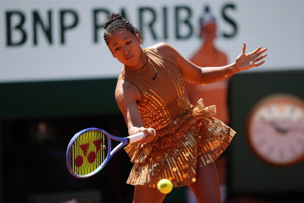 That revealed a sparkling, gold, Eiffel Tower-inspired outfit underneath (AP)