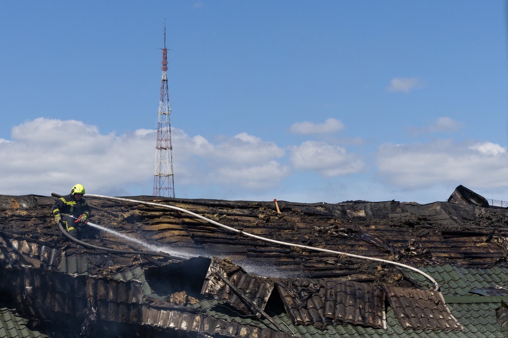 A firefighter uses a hose on smoldering remnants on the roof of the National Chernobyl Museum, heavily damaged by an overnight Russian airstrike, in Kyiv (AFP/Getty)