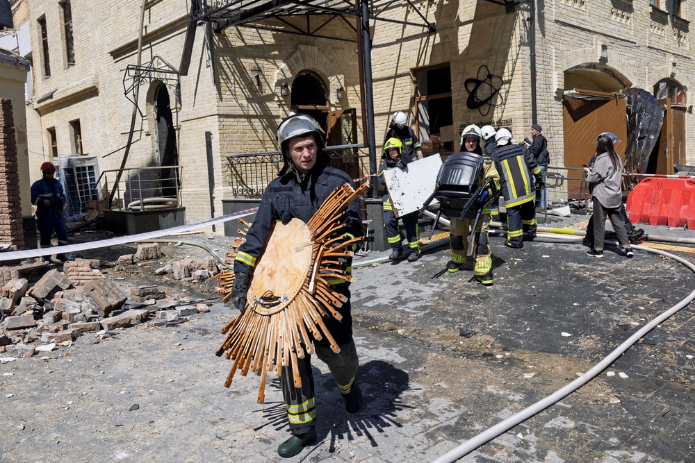 Rescuers and first responders carry out damaged exhibits from the National Chernobyl Museum, heavily damaged by an overnight Russian airstrike, in Kyiv on May 24, 2026, amid the Russian invasion of Ukraine. (AFP/Getty)