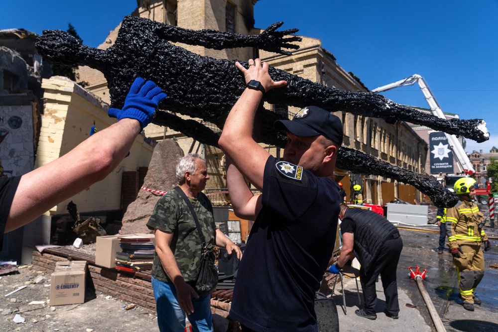 A policeman carries out a damaged exhibit from the National Chernobyl Museum, heavily damaged by an overnight Russian airstrike, in Kyiv (AFP/Getty)
