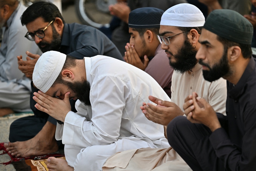 Muslim devotees offer Eid al-Adha prayers at a mosque in Karachi on 27 May 2026 (AFP/Getty)