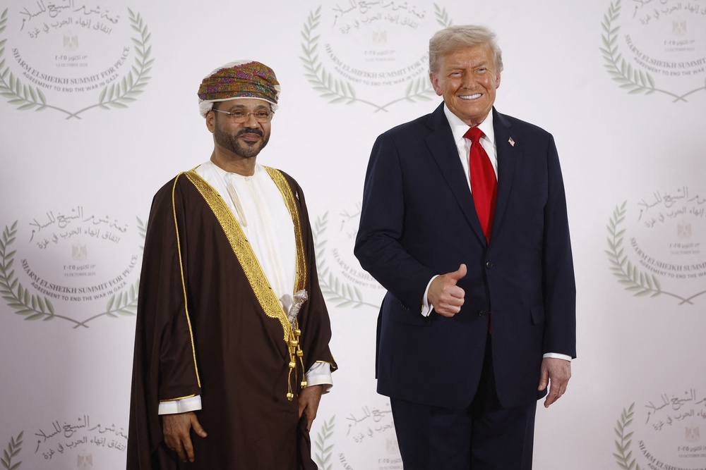 Oman's Foreign Minister Sayyid Badr Albusaidi (L) and US President Donald Trump pose during a summit on Gaza in Sharm el-Sheikh on October 13, 2025 (AFP/Getty)