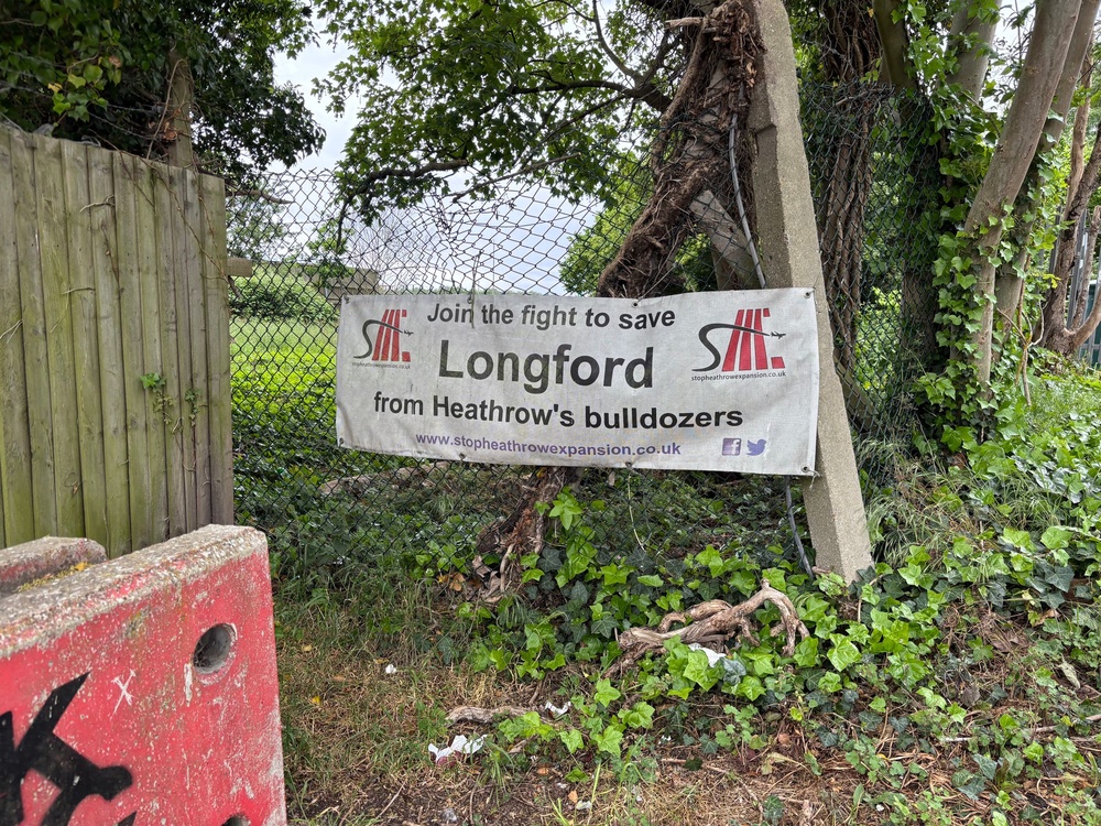 Signs opposing the expansion of Heathrow are dotted around the village of Longford (The Independent)