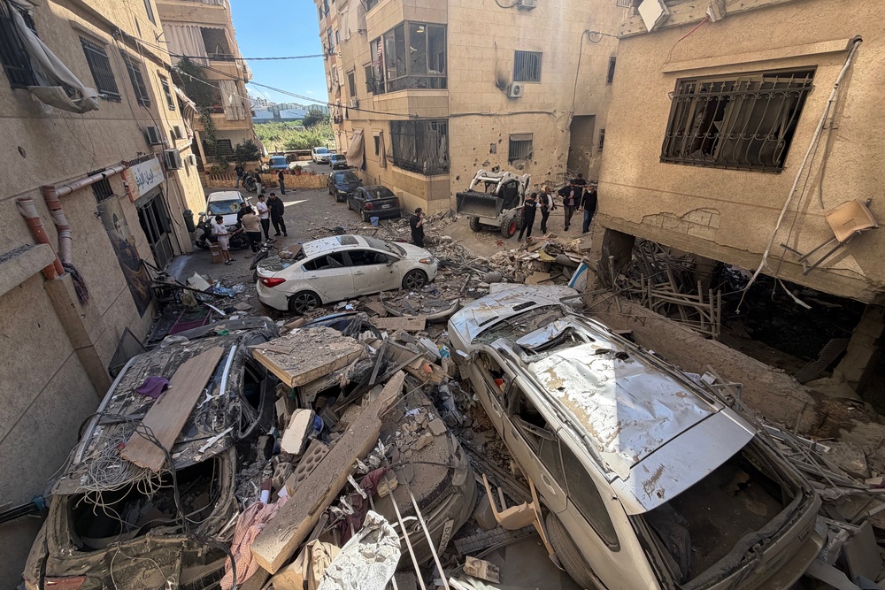 Rescue workers and local residents inspect the damage to a building following an Israeli air strike in the Choueifat area, south of Beirut on the outskirts of the capital's southern suburbs, on May 28 (AFP/Getty)