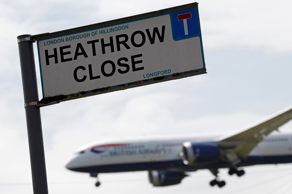 A British airways aircraft prepares to land at Heathrow airport, beyond the village of Longford in west London (AFP/Getty)