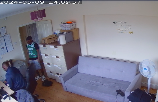 A CCTV grab shows Rahman being handed a knife from the set kept in the supported accommodation office (Metropolitan Police)