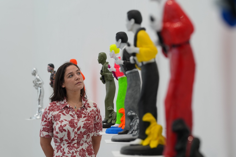 A visitor inspecting White’s works (Lucy North/PA) (PA Wire)