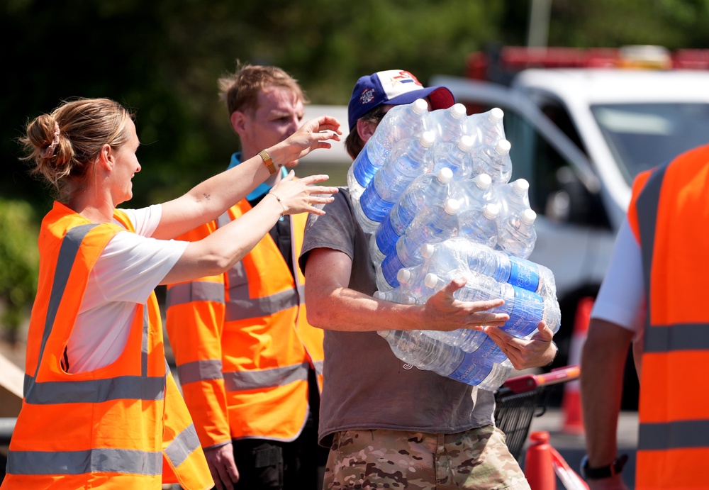 A man collects bottled water at a water collection point at a Sainsbury’s near Whitstable, Kent (Gareth Fuller/PA) (PA Wire)