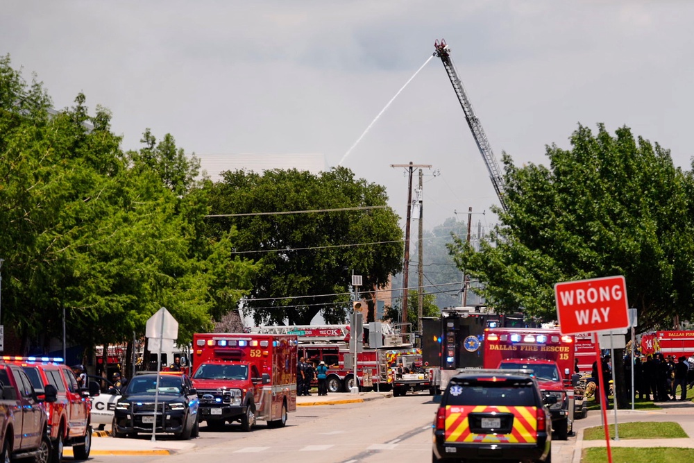 Dozens of firefighters searched through the smoldering rubble of the building on the outskirts of downtown Dallas (AP Photo/Gabriela Passos)