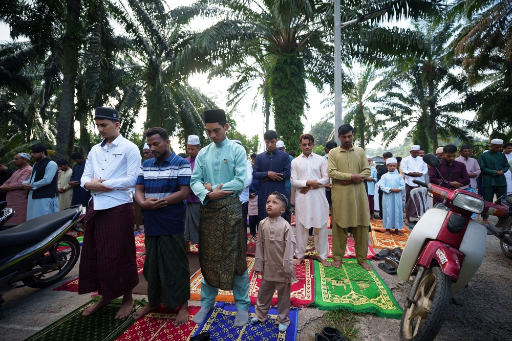 Rohingya muslims perform morning prayer marking Eid al-Adha outside a mosque in Klang, outskirt of Kuala Lumpur, Malaysia (AP)