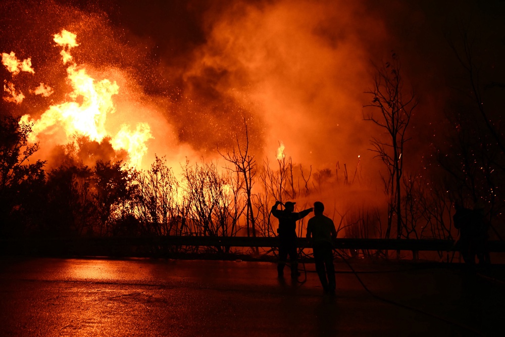 Firefighters work to extinguish a wildfire near the city of Patras in western Greece (AFP/Getty)
