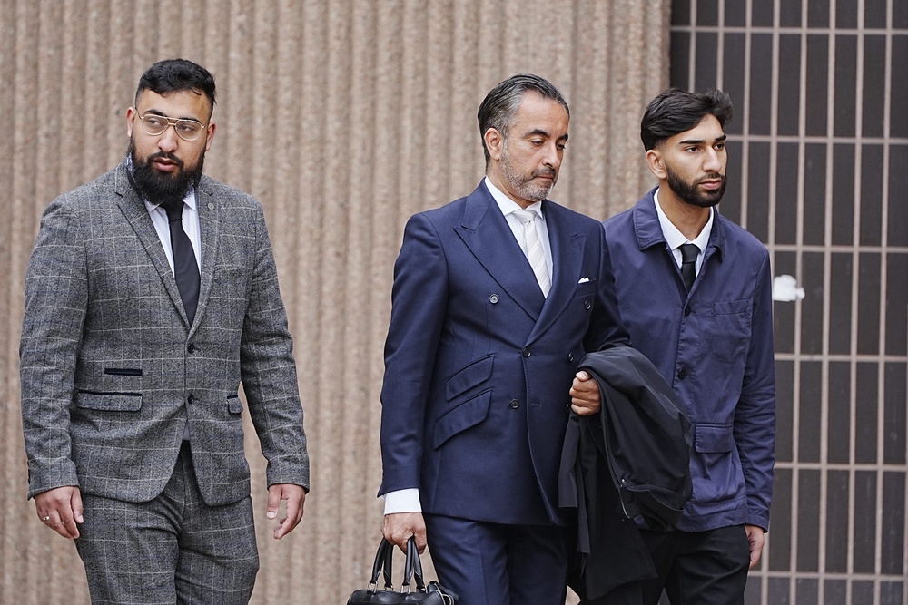 Human Rights lawyer Aamer Anwar (centre) arrives with Muhammad Amaad (left) and Mohammed Fahir Amaaz (right) at Liverpool Crown Court for an earlier appearance (PA Archive)