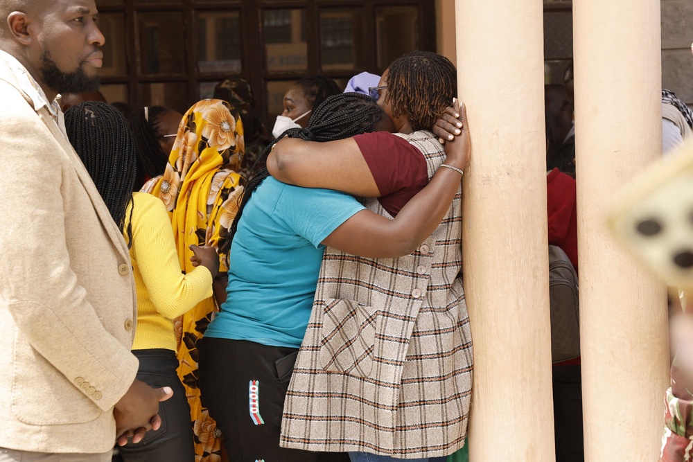 Relatives comfort each other at Utumishi Girls Academy following the deadly fire in Gilgil, north of the capital Nairobi on May 28, 2026 (AFP via Getty Images)