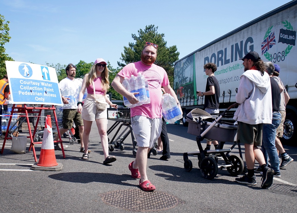 People queue for bottled water from a water collection point at a Sainsbury’s near Whitstable, Kent (Gareth Fuller/PA) (PA Wire)