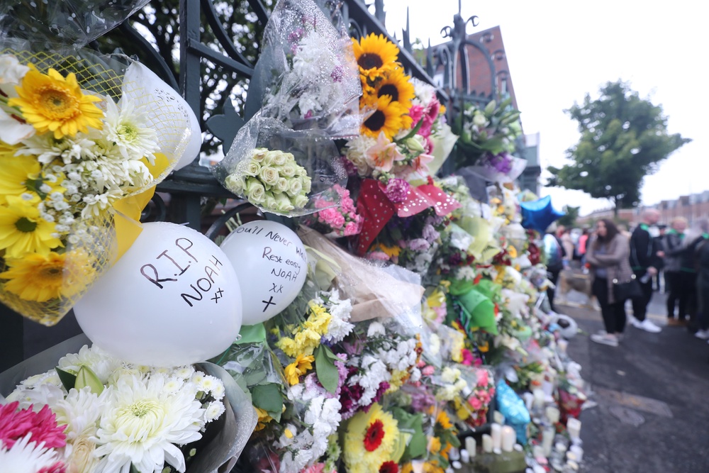 Floral tributes to Noah Donohoe at St Malachy’s College where he went to school in Belfast (Niall Carson/PA) (PA Archive)