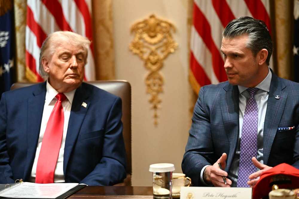 Donald Trump is reportedly at odds with his defence secretary Pete Hegseth (R) over the memorandum of understanding (AFP/Getty)