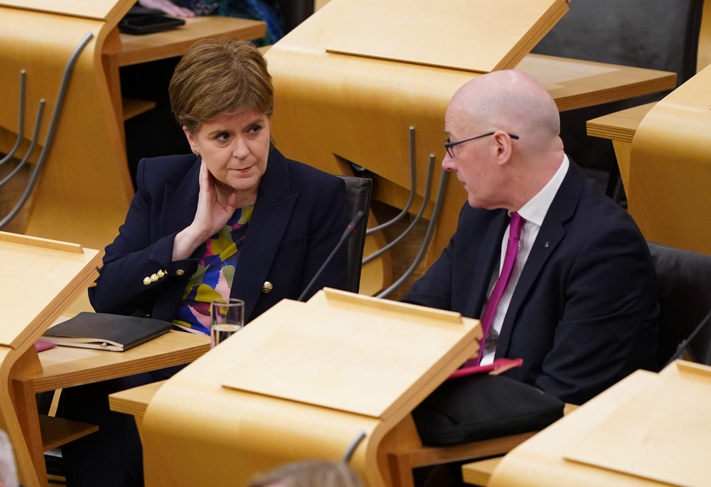Nicola Sturgeon and John Swinney at the Scottish Parliament in 2024 (Andrew Milligan/PA) (PA Archive)