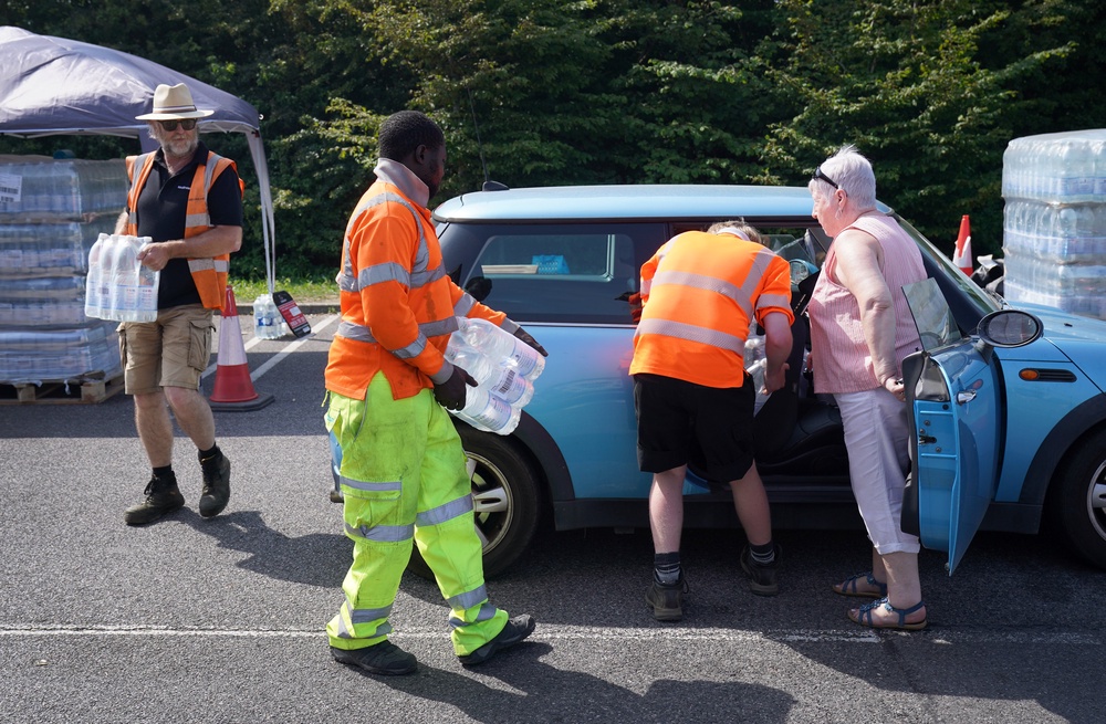A woman’s car is loaded at a water collection point near Herne Bay in Kent (Gareth Fuller/PA) (PA Wire)