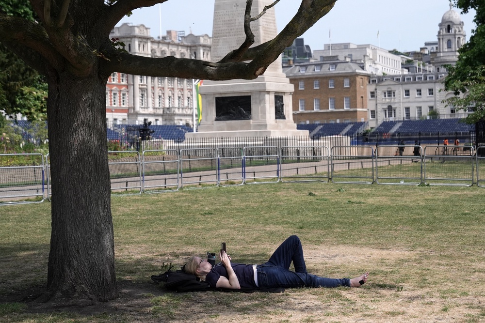 A person seeks shade in St James’s Park in central London (Stefan Rousseau/PA) (PA Wire)
