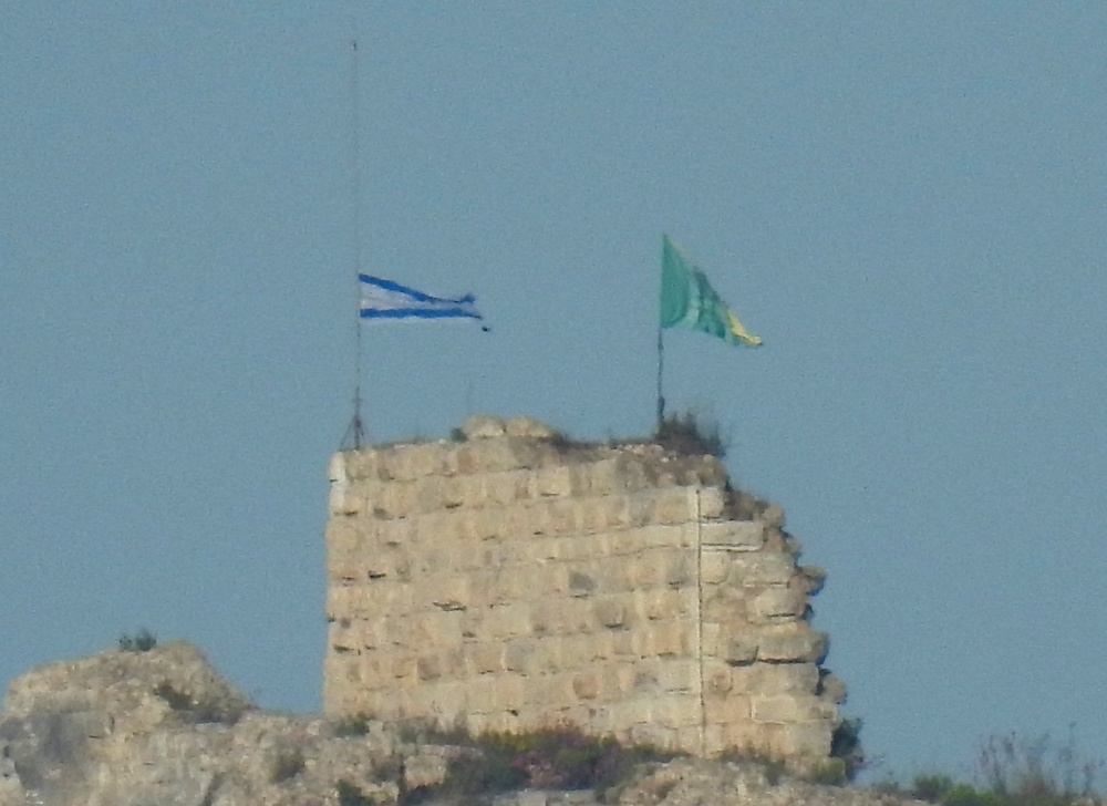 An Israeli flag and a flag of the Golani Brigade are raised on Beaufort Castle, as seen from Marjayoun, southern Lebanon (Reuters)